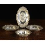 Four Small Decorative Silver Dishes: A pair of oval bonbon dishes by Deakin & Francis Ltd;
