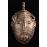 A Rare African Bronze Face Mask with a rope-twist ring to the top, 6" x 3½" (15 cm x 9 cm).