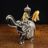 A 19th Century Indian Silver Mounted Carved Ebony Elephant.