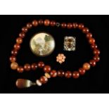 A Scottish Agate Bead Necklace with striated pendant,