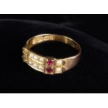 An Antique 15ct Gold Buckle Ring, hallmarked Birmingham 1918, set with two rubies and seed pearls,