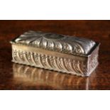 A Silver Metal Box of rectangular form with embossed gadrooning to the cushion moulded lid
