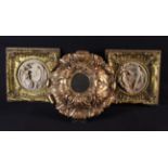 A Small Mirrored Roundel in an elaborate faux giltwood frame of moulded resin with bold crested