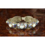 A Silver Gilt Filigree Bracelet composed of seven hinged cushion links set with white jade