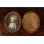 An 18th Century Miniature Portrait of a Lady set in an oval box clad in pink silk. 2¾" x 2¼" (6.