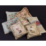 A Group of Seven Decorative Scatter Cushions: One of floral wool-work on a beige ground edged with