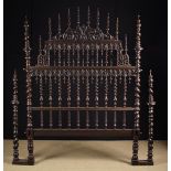 An Antique Portuguese Turned Ebony Bed Head composed of baluster knopped barleytwist spindles