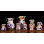 A Group of Eight Masons Ironstone Jugs of octagonal form: Seven of graduated heights decorated in