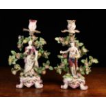 A Pair of Mid 18th Century Bow Porcelain Figural Candlesticks modelled as a gardener & his