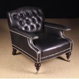 A Large Black Leather Upholstered Armchair with buttoned back,