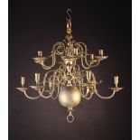 A 19th Century Twelve Branch Brass Chandelier in the 18th Century Dutch Style.