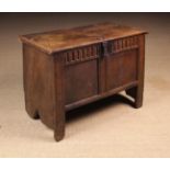 A Small 16th/17th Century Oak Coffer, possibly for a Child, of joined and boarded construction.