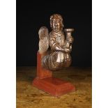 A 16th Century English Oak Figural Candleholder/Sconce carved in the form of a winged angel in
