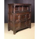 A Fine 17th Century Joined Oak One-Piece Court Cupboard having a recessed upper cupboard above two