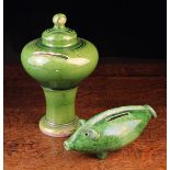 Two Green-glazed Pottery Money Boxes: One having a turned bulbous chamber surmounted by a