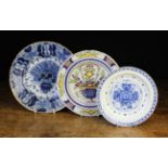 Three Late 18th Century Delft Plates: The largest blue & white decorated with 'peacock feather'