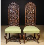 A Pair of Fine Carved Walnut Daniel Marot style Chairs: The tall arch topped backs pierced and