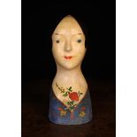A French 19th Century Painted Papier-mâché Milliner's Head decorated with corsage of flowers and