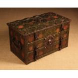 A 17th Century Wrought Iron Armada Chest bound in studded straps and enriched with decorative
