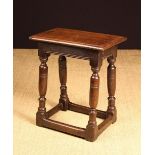 A Mid 17th Century Oak Joint Stool with turned legs and riven top, 20" (51 cm) high,