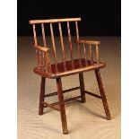 A 19th Century Primitive Welsh Comb-back Windsor Armchair of modest proportions retaining residual