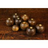 Eight Turned Lignum Carpet Bowls in two sets numbered with 1 - 4 and an accompanying jack.