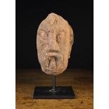 A Rare 12th Century Architectural Stone Fragment carved in the form of a Head with slanted almond