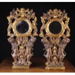 A Pair of Delightful Early 18th Century Giltwood Looking Glasses held aloft by pairs of carved