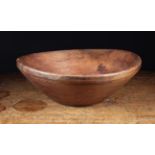 A Large, Shallow Dug Out & Turned Treen Bowl with slightly raised foot, 3 in (8 cm) high,
