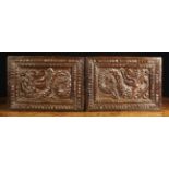 A Pair of Oak Panels; Each carved with a barb-tongued wyvern with a coiled scaly tail,