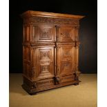 A Splendid 17th Century Flemish Carved Oak Cupboard in two sections.
