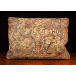 A Rectangular Cushion covered in a remnant of 17th/Early 18th Century Tapestry woven with an urn