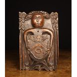 A Rare 16th Century Carved Oak Panel/Boss emblazoned with an angel bearing an armorial shield.