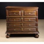 A Charles II Moulded Oak Chest of Drawers enriched with faux mulberry wood-graining to the facade