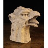 A Gothic Carved Sandstone Head of a Griffin, 15th century, 9½" (24 cm) high.