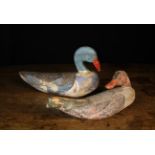 Two Vintage Painted Wooden Decoy Ducks: One having a pine head with repaired bill and a palm wood