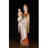 A 16th Century Polychromed Wood Carving of The Virgin & Child: Mary depicted with long flowing