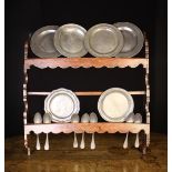 An Early 19th Century Provincial Wall Rack with pewter plates and spoons.