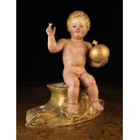 An 18th Century Carved and Polychromed Figure of The Christ Child depicted with curly golden hair