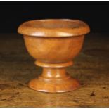 A 19th Century Turned Elm Master Salt with everted rim, a scotia moulded stem and round foot,