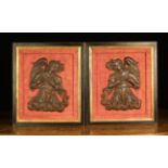 A Pair of 17th Century Flemish Oak Relief Carvings of winged angels above billowing clouds.