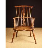 An 18th Century Ash & Elm Comb-back Windsor Armchair of unusual form attributed to the Thames