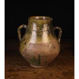 An Antique French Provincial Twin-handled Clay Pot semi-glazed in dripped green and ochre,