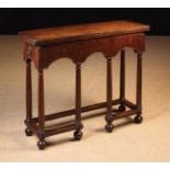 An Early 18th Century Oak Table with fold over top above an arcaded apron incorporating swing-out