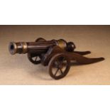 An Early 19th Century Walnut Cannon; the stop fluted barrel with brass mounts,