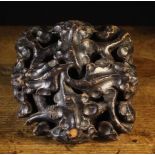 A 16th Century Walnut & Pine Roof Boss elaborately carved with a swirl of interlaced stems and oak