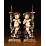 A Pair of Decorative Polychromed Wooden Figural Pricket Candlesticks, 20th century.