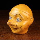 An Early 20th Century Italian Polychrome Glazed Terracotta Money Box in the form of a head,