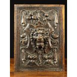 A 19th Century Renaissance Revival Oak Panel carved in relief with a lion mask on scrolled