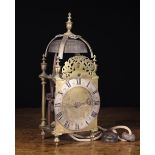 A Brass Lantern Clock (A/F) The silvered 6" (15 cm) diameter chapter ring enclosing an engraved